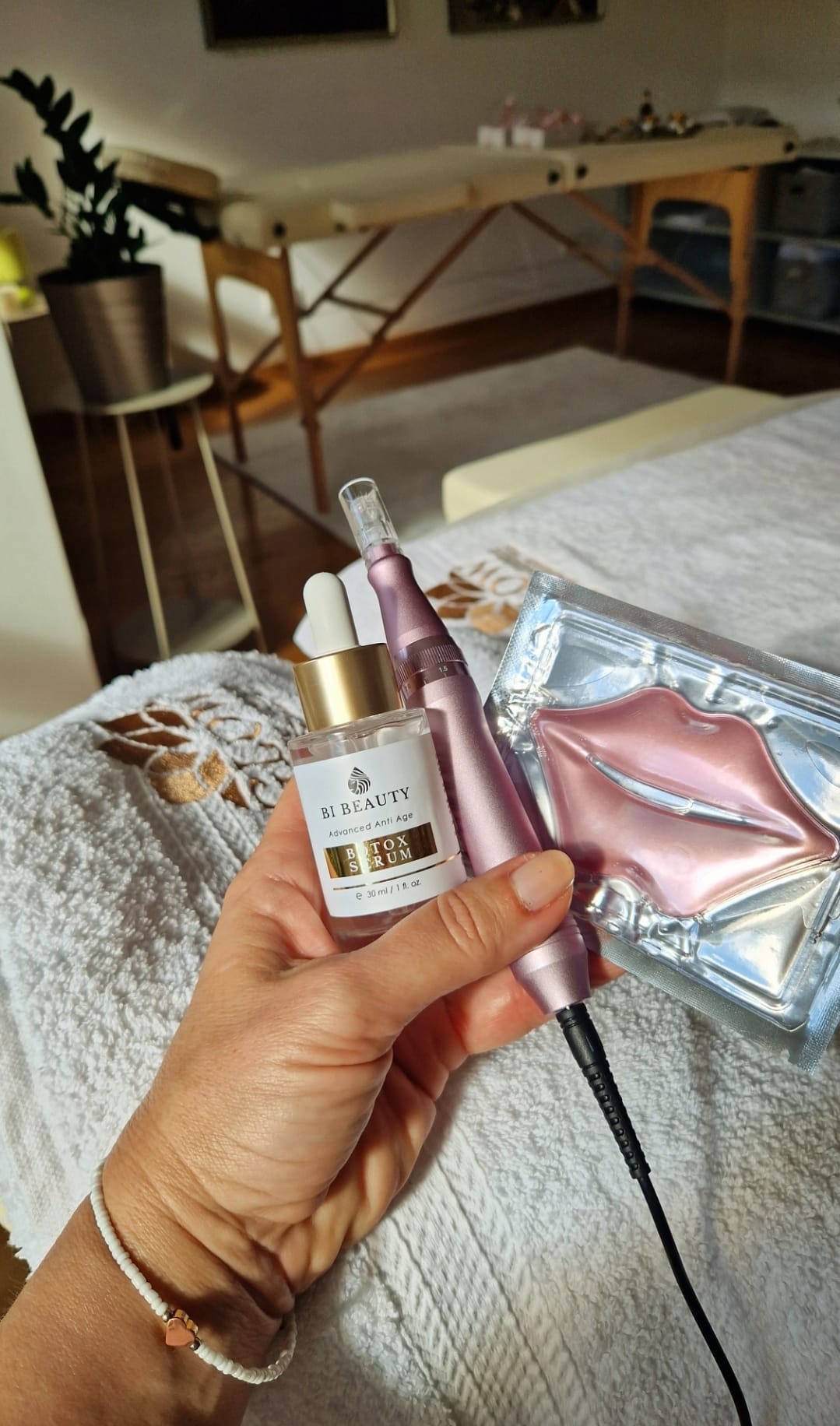 Kosmetičarka u sterilnoj rukavici drži Dermapen microneedling aparat i bočicu seruma bogatog hijaluronskom kiselinom, prikazujući kompletne proizvode korišćene za tretman.